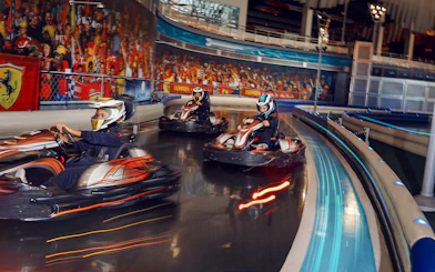 Go-kart racing at Ferrari World Abu Dhabi indoor track.