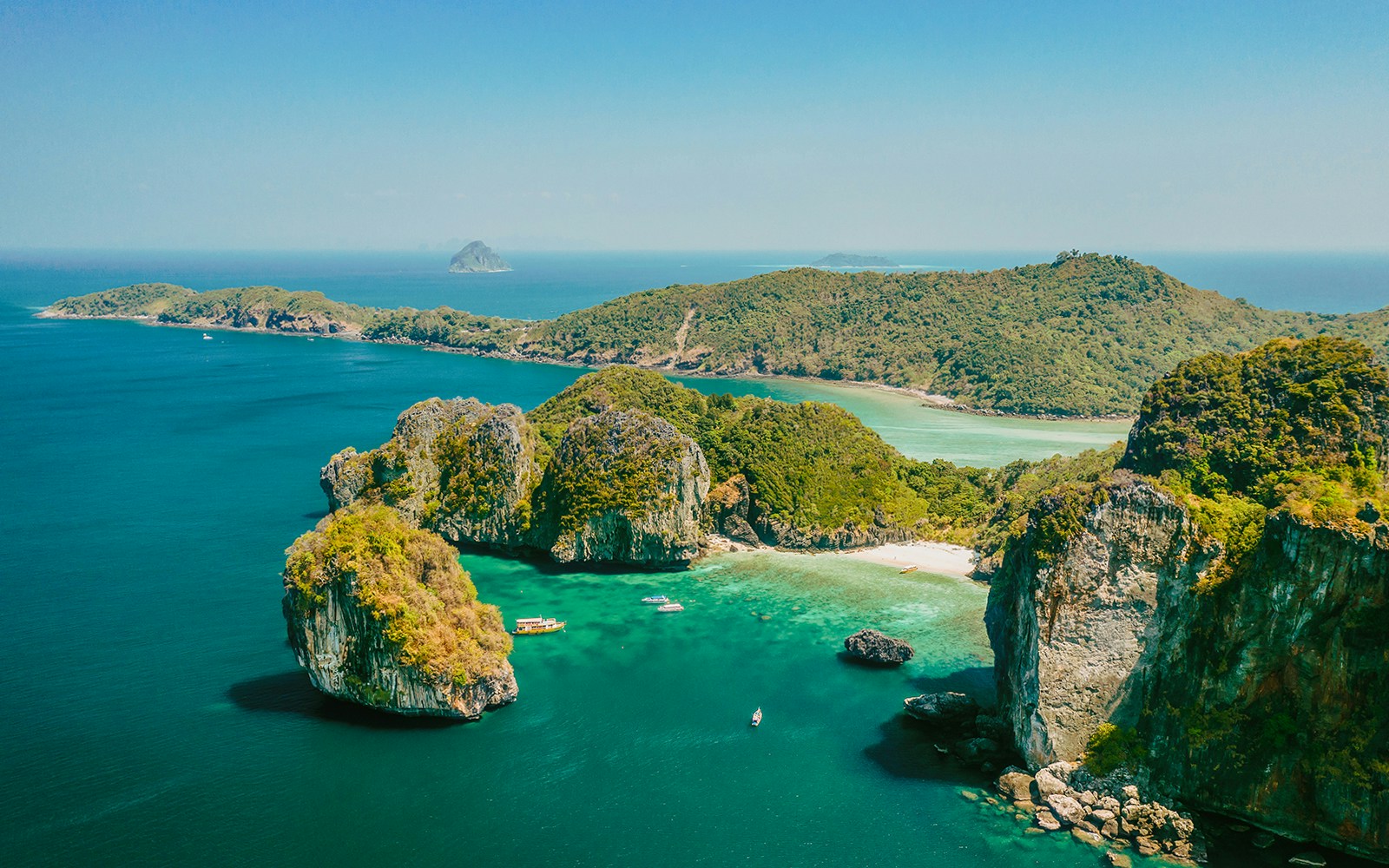 Aerial view of limestone cliffs and turquoise waters at James Bond Island, Thailand.