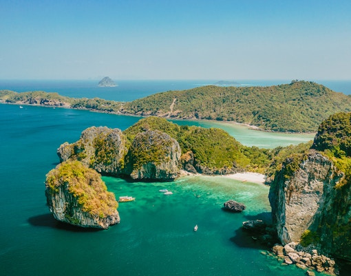 Aerial view of limestone cliffs and turquoise waters at James Bond Island, Thailand.