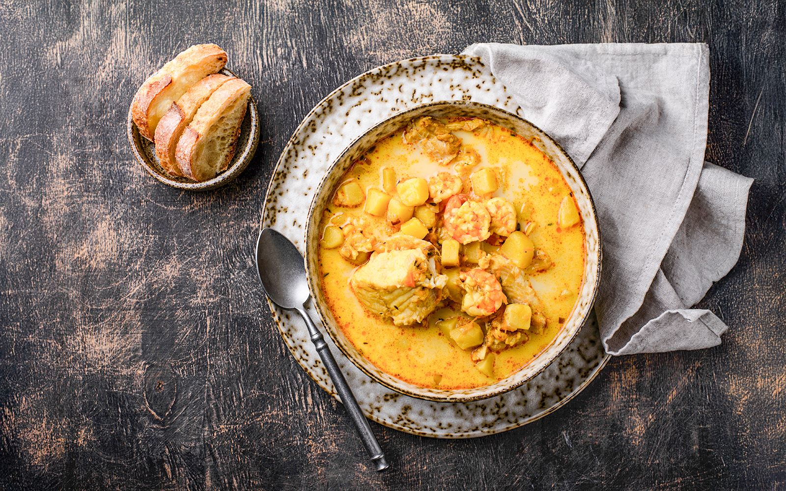 Icelandic fish soup with shrimps and curry served with bread.