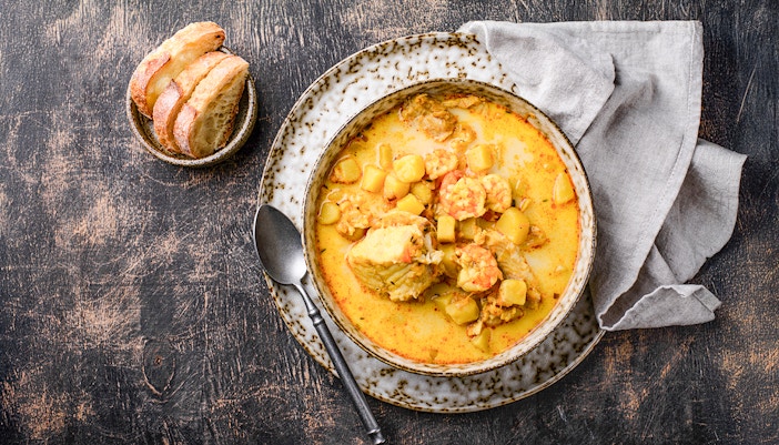 Icelandic fish soup with shrimps and curry served with bread.