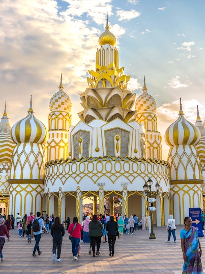 Visitors entering the ornate entrance of Global Village in Dubai.