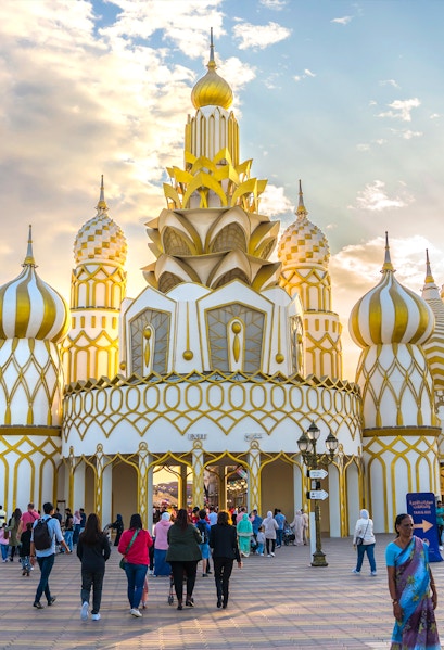 Visitors entering the ornate entrance of Global Village in Dubai.