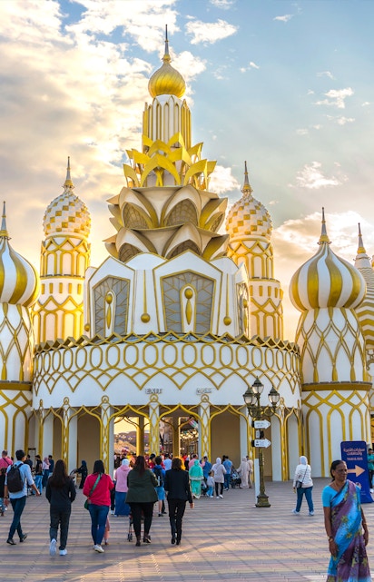 Visitors entering the ornate entrance of Global Village in Dubai.