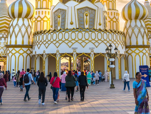 Visitors entering the ornate entrance of Global Village in Dubai.