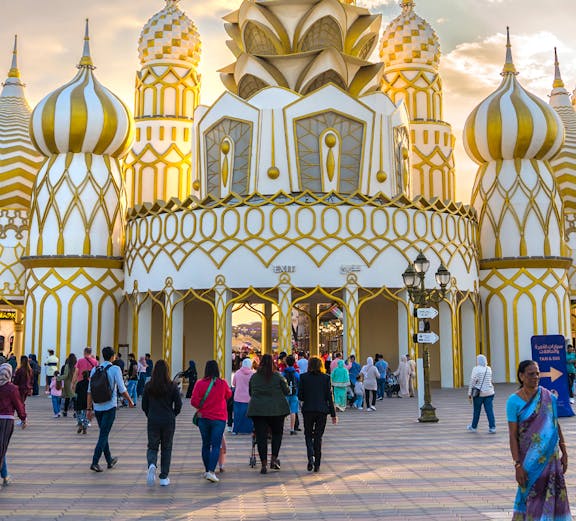Visitors entering the ornate entrance of Global Village in Dubai.