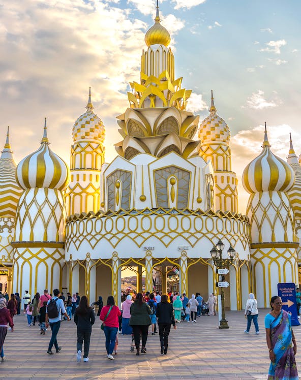 Visitors entering the ornate entrance of Global Village in Dubai.