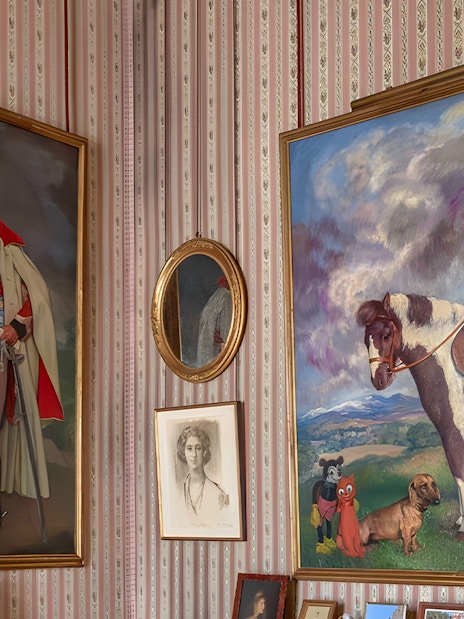 Paintings in Liria Palace featuring a man with a dog and a child on a horse.