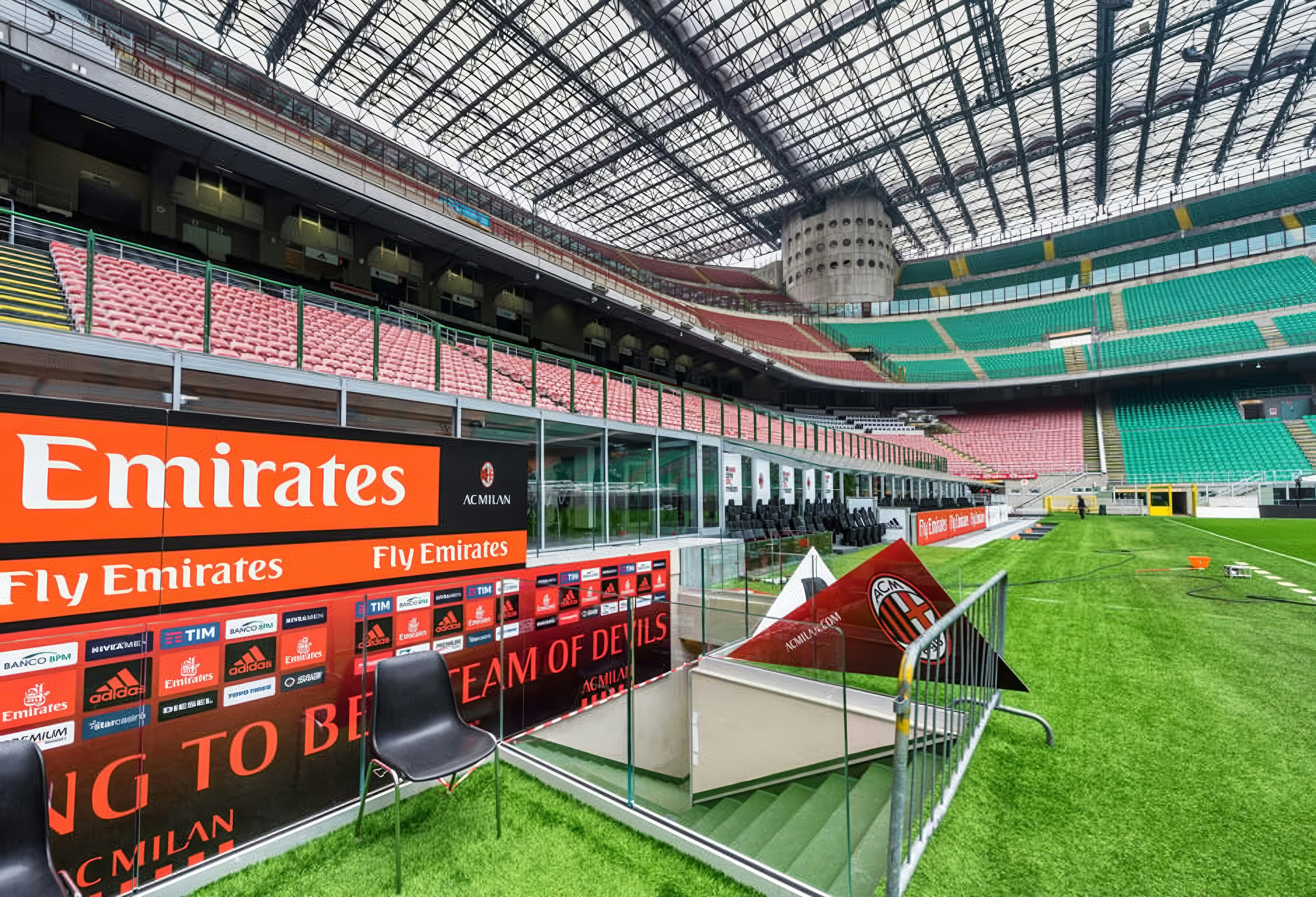 Players tunnel at San Siro stadium with seating and field view.