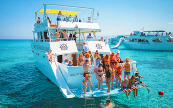Tourists enjoying a boat trip at Blue Lagoon near Paphos, Cyprus.