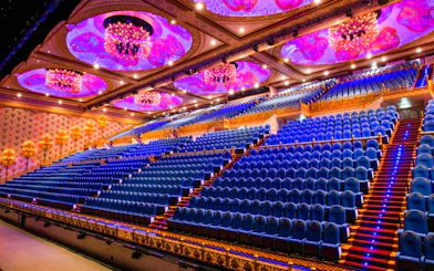 Grand theater seating with ornate ceiling at Carnival Magic Phuket.