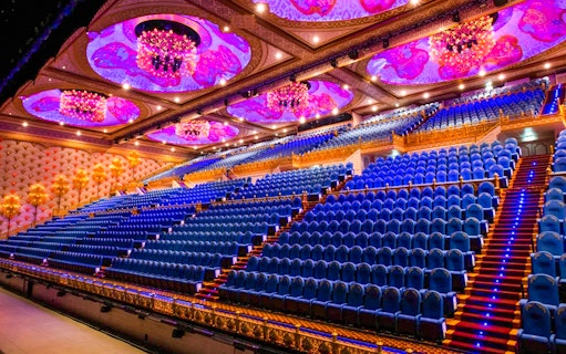 Grand theater seating with ornate ceiling at Carnival Magic Phuket.