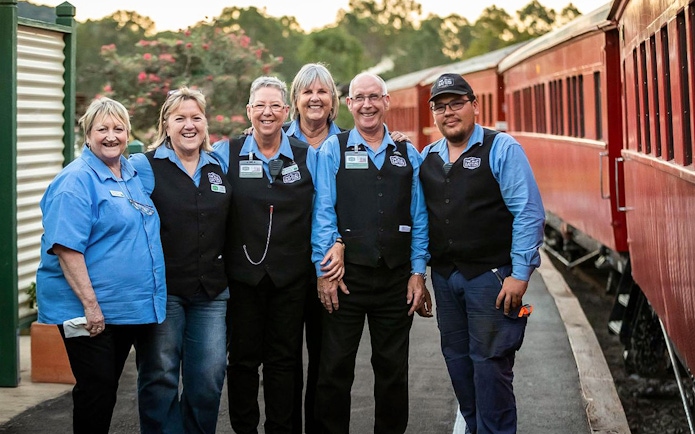Mary Valley Rattler staff standing by the train in Gympie.
