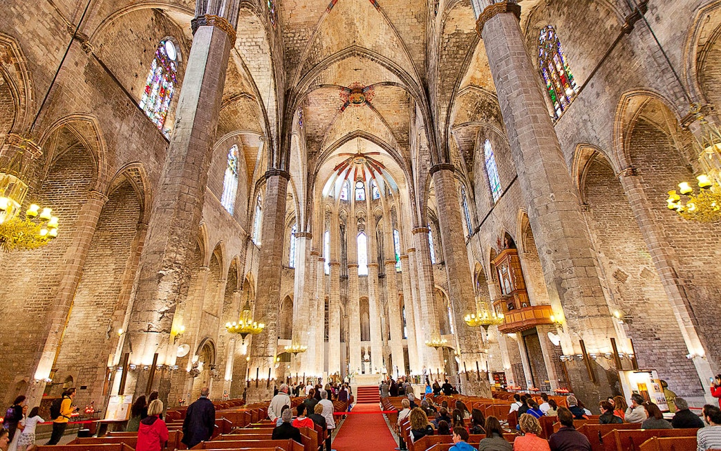 Interior of Santa Maria del Mar with visitors on a guided tour, Barcelona.