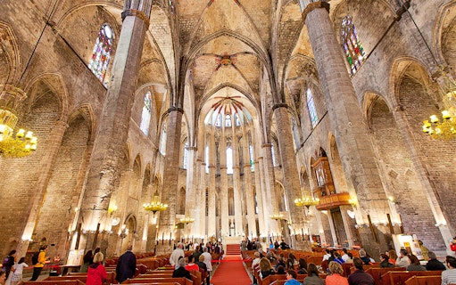 Interior of Santa Maria del Mar with visitors on a guided tour, Barcelona.