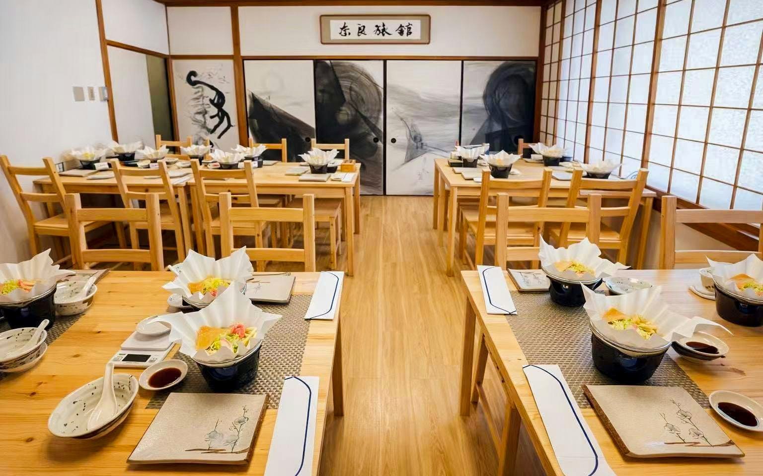 Tables set for sushi making workshop in Osaka with ingredients and utensils.