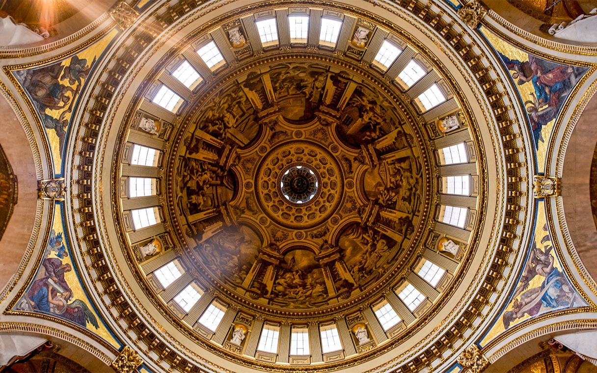 Intricate frescoes and architectural details on St. Paul's Cathedral dome, London.