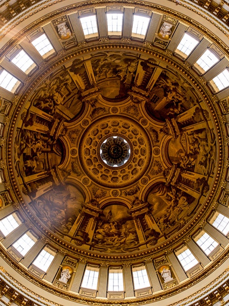 Intricate frescoes and architectural details on St. Paul's Cathedral dome, London.