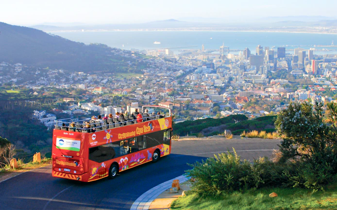 Open-top bus overlooking Cape Town cityscape on hop on hop off tour.
