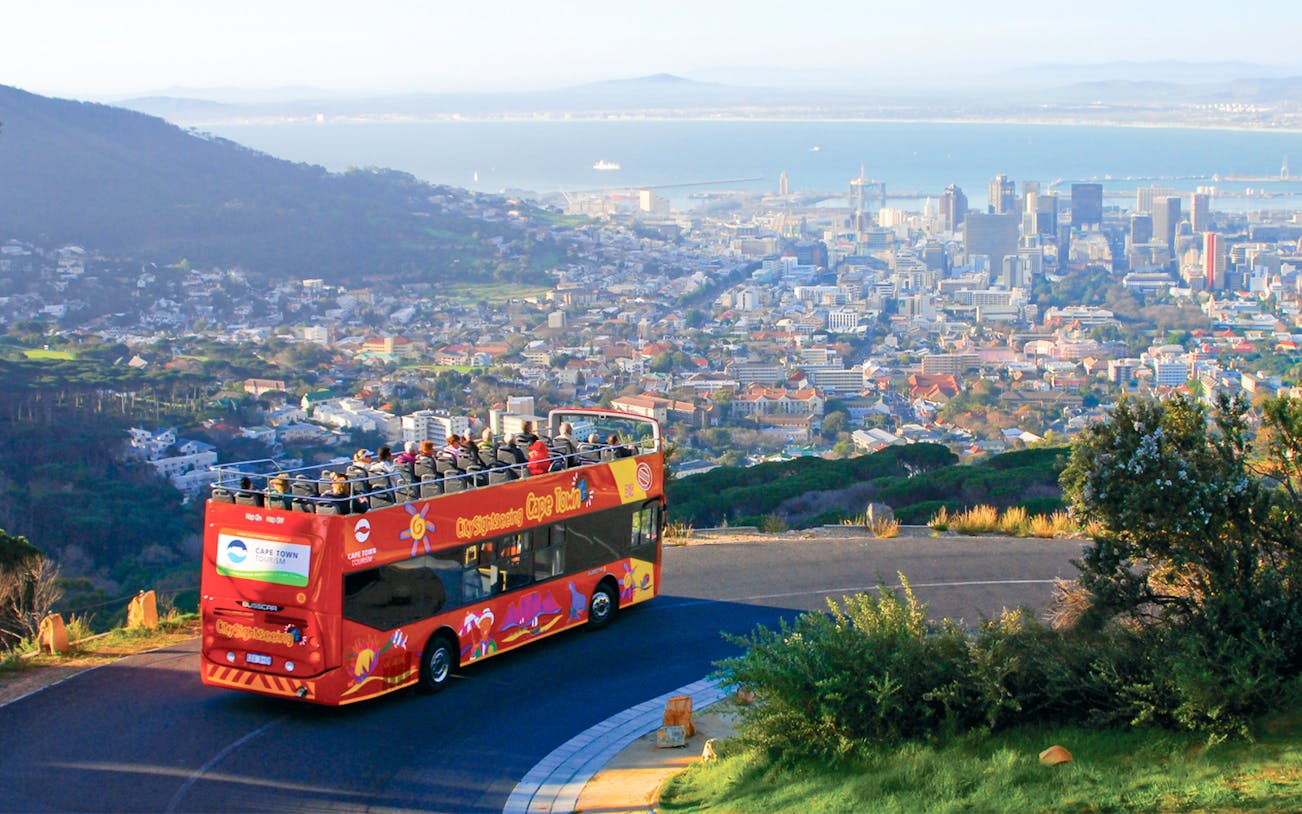 Open-top bus overlooking Cape Town cityscape on hop on hop off tour.