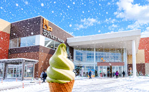 Mitsui Outlet Park in winter with matcha ice cream cone, Hokkaido tour.