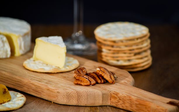 Cheese and crackers with pecans on a wooden board at Taylor's Port Wine Shop & Tasting Room.