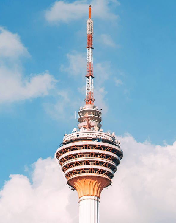 KL Tower with ARAS Revolving Restaurant against blue sky, Kuala Lumpur.