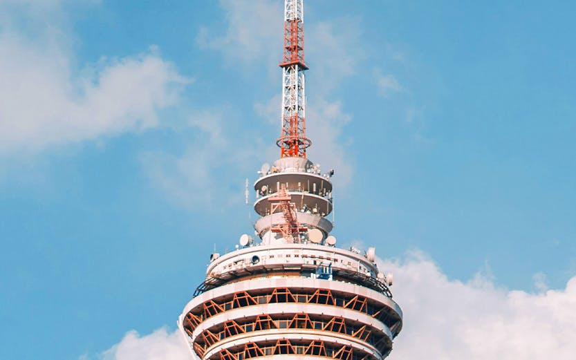 KL Tower with ARAS Revolving Restaurant against blue sky, Kuala Lumpur.