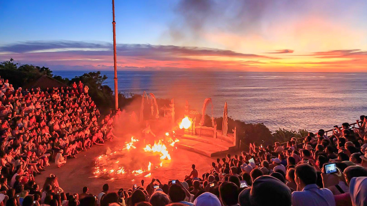 Sunset Kecak dance performance at Uluwatu Temple, Bali, with ocean view.