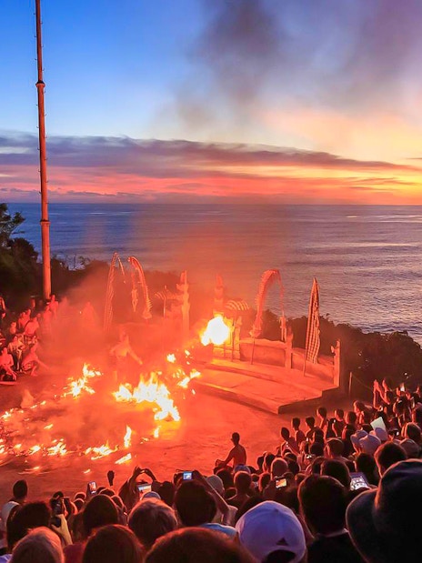 Sunset Kecak dance performance at Uluwatu Temple, Bali, with ocean view.
