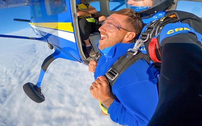 Tandem skydiving over Newcastle Beach, Sydney, with a view from the plane door.