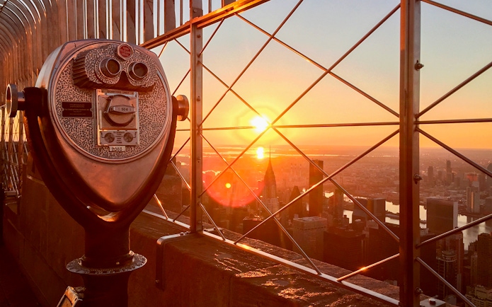 Observation deck view at sunrise from the 86th floor with city skyline.