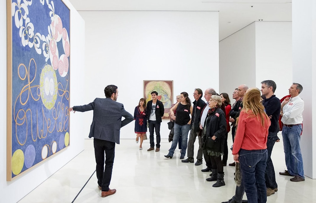 Visitors exploring artwork at Picasso Museum, Malaga.