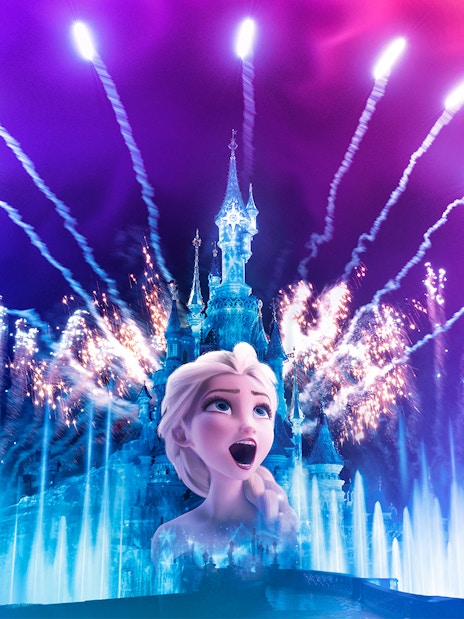 Fireworks over Sleeping Beauty Castle at Disneyland Paris with character projection.