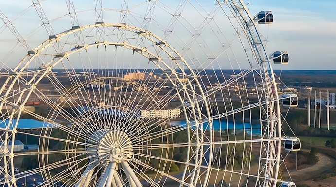 Ferris wheel at Icon Park, Orlando, with cityscape in the background.