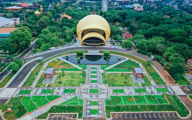Aerial view of Taman Mini Indonesia's iconic dome and gardens in Jakarta.