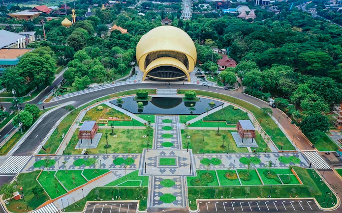 Aerial view of Taman Mini Indonesia's iconic dome and gardens in Jakarta.