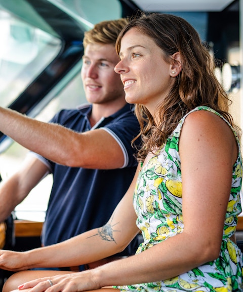 Luxurious cruise ship deck with pool, sun loungers, and ocean view, highlighting onboard amenities.