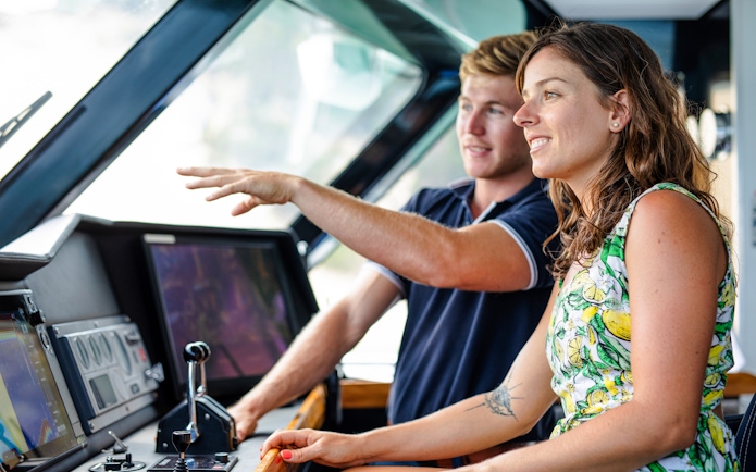 Luxurious cruise ship deck with pool, sun loungers, and ocean view, highlighting onboard amenities.