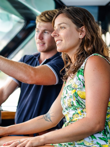 Luxurious cruise ship deck with pool, sun loungers, and ocean view, highlighting onboard amenities.