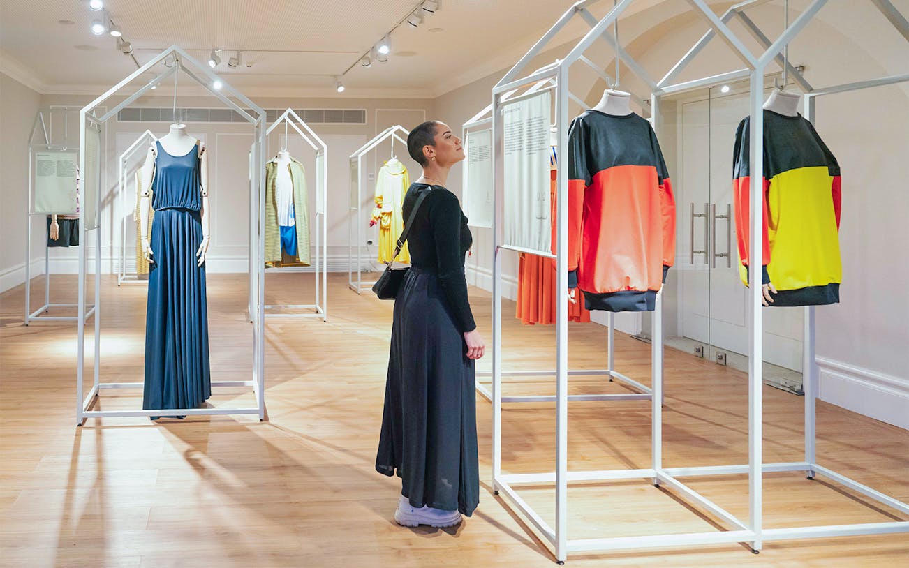 Visitor exploring exhibits at Porto Fashion and Fabric Museum.
