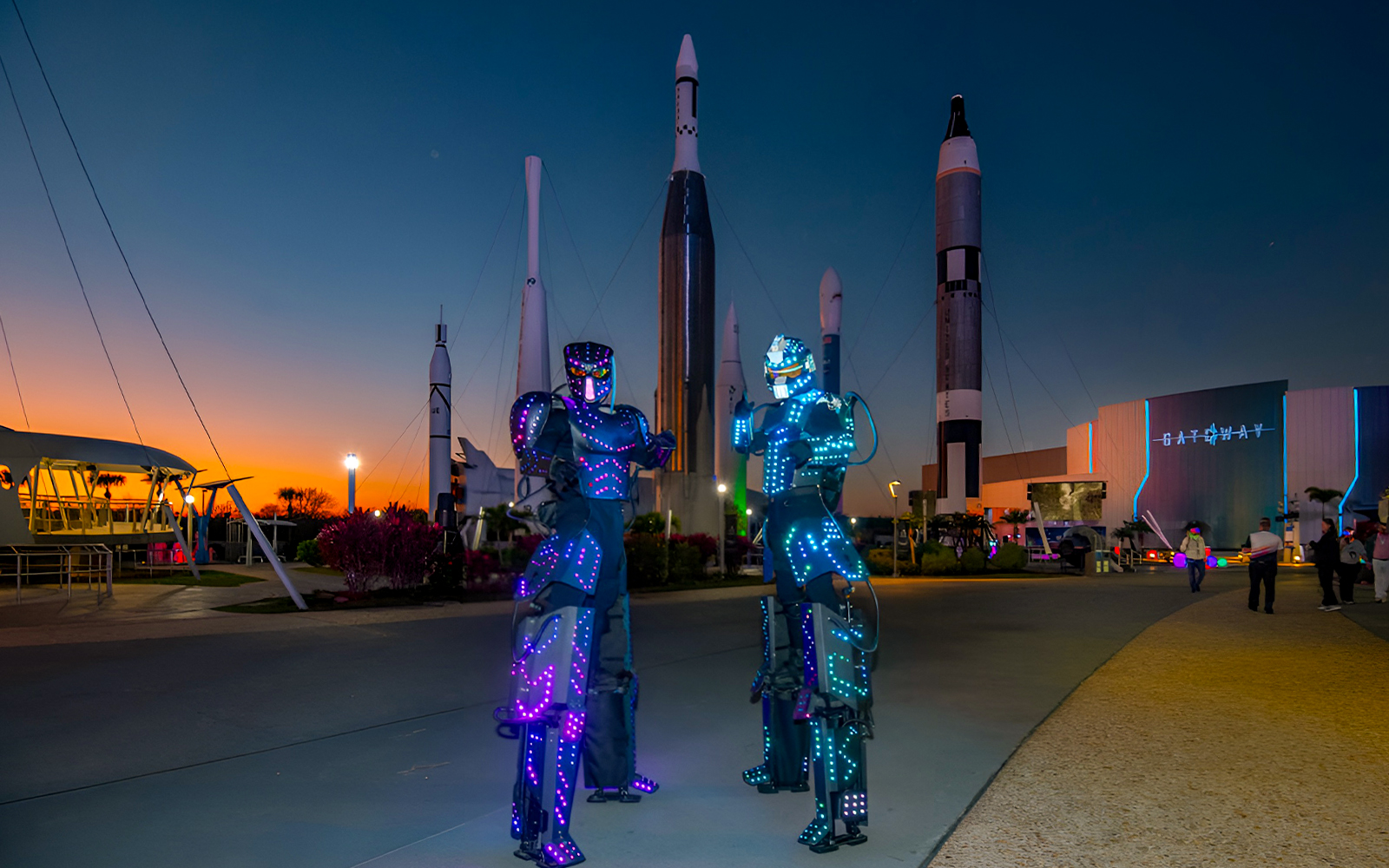 Kennedy Space Center with Christmas decorations, featuring a festive rocket display.