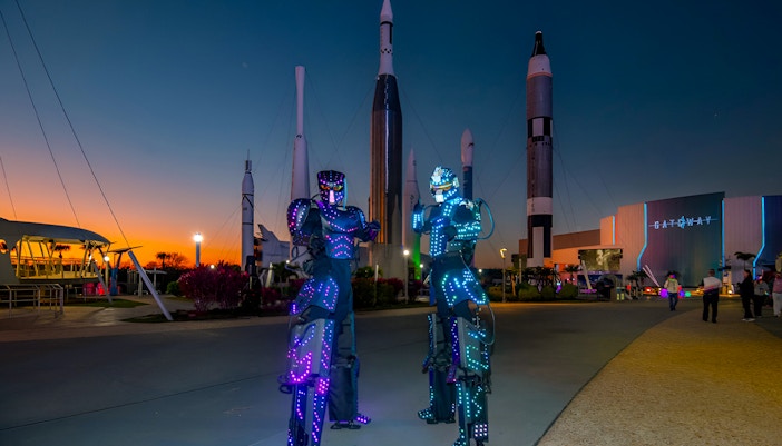 Kennedy Space Center with Christmas decorations, featuring a festive rocket display.