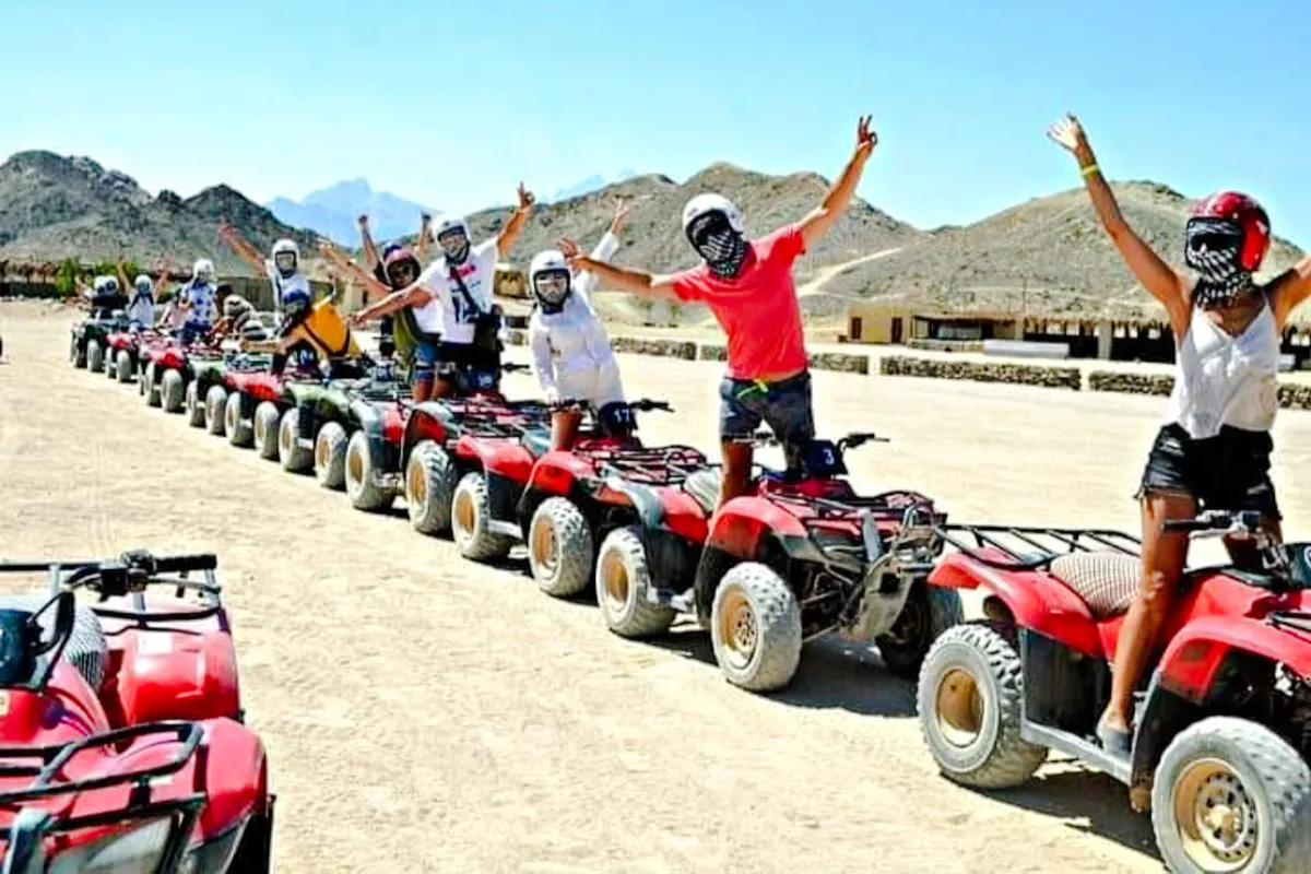 Group on quad bikes during Hurghada desert safari tour.