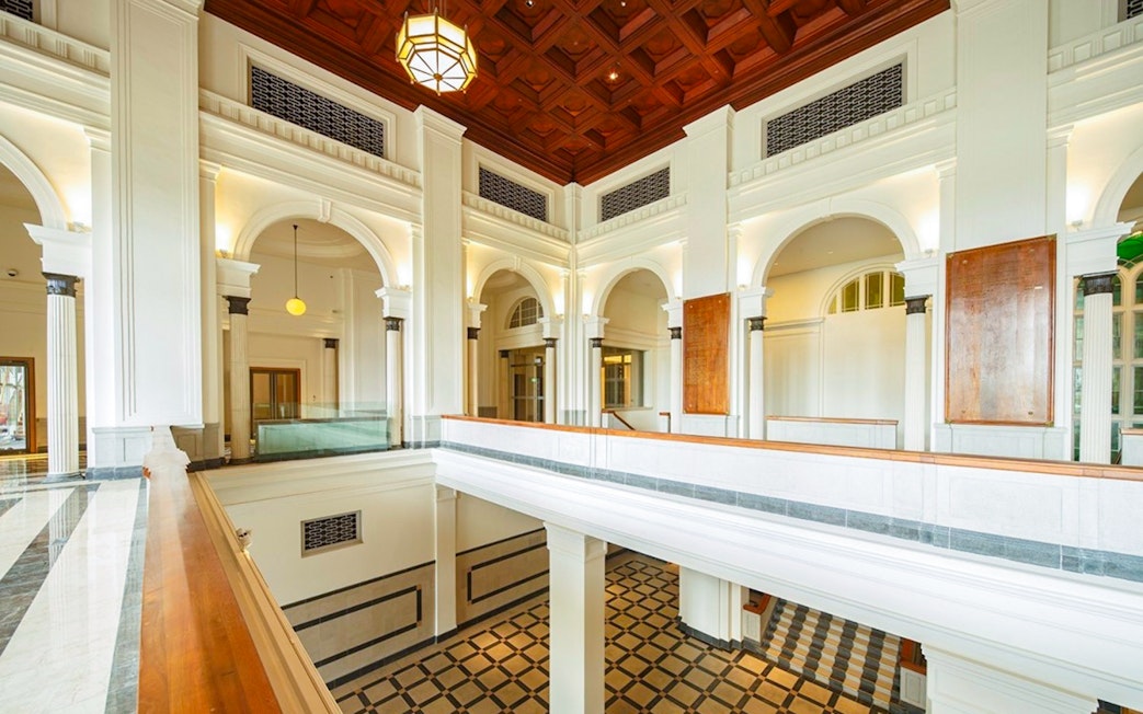 National Gallery Singapore interior with arches and checkered floor.