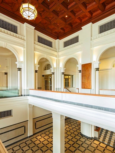 National Gallery Singapore interior with arches and checkered floor.