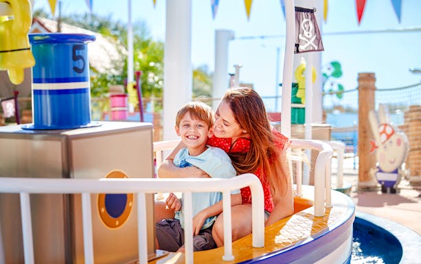 Mother and child enjoying a ride at Peppa Pig Park, Guntzburg.