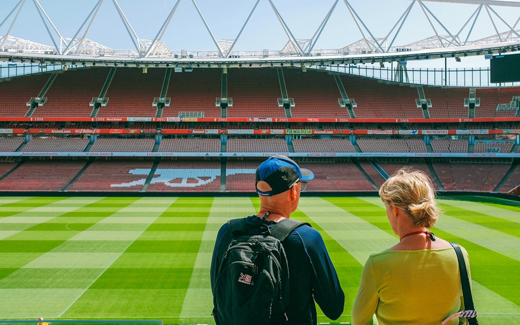 Visitors overlooking the field at Emirates Stadium, London.