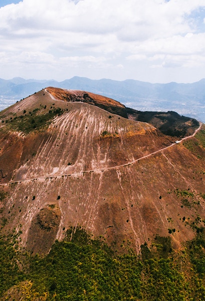Aerial view of Mount Vesuvius crater with surrounding landscape in Italy.