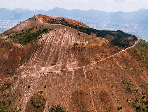 Aerial view of Mount Vesuvius crater with surrounding landscape in Italy.